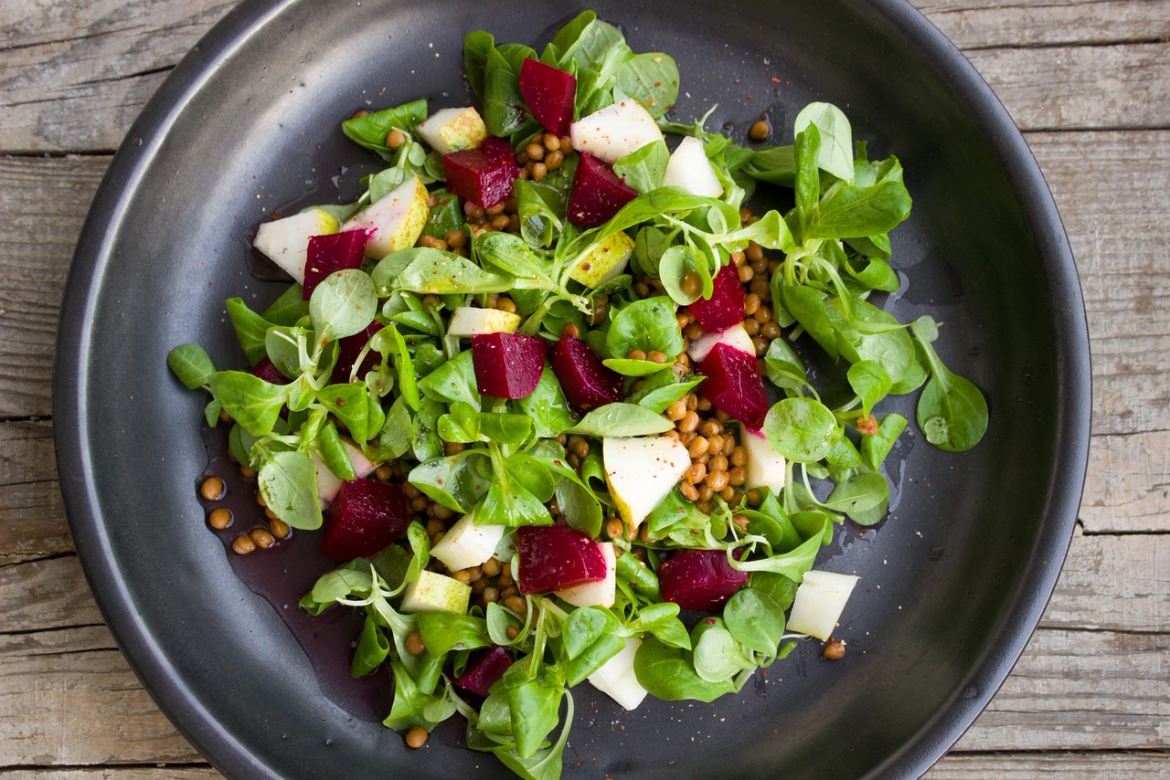 Salad with green lettuce, tomatoes and cucumbers, and radishes