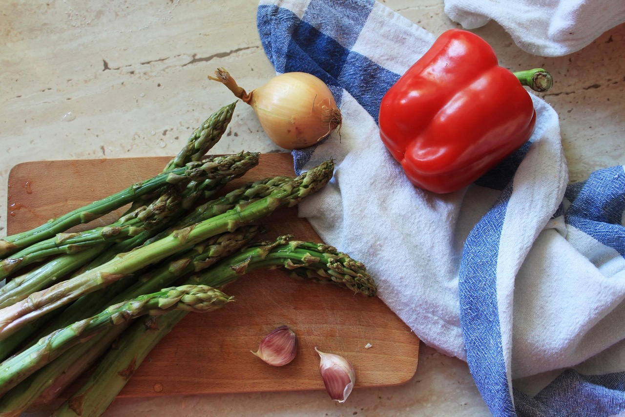 Green asparagus in a pan with Parmesan cheese